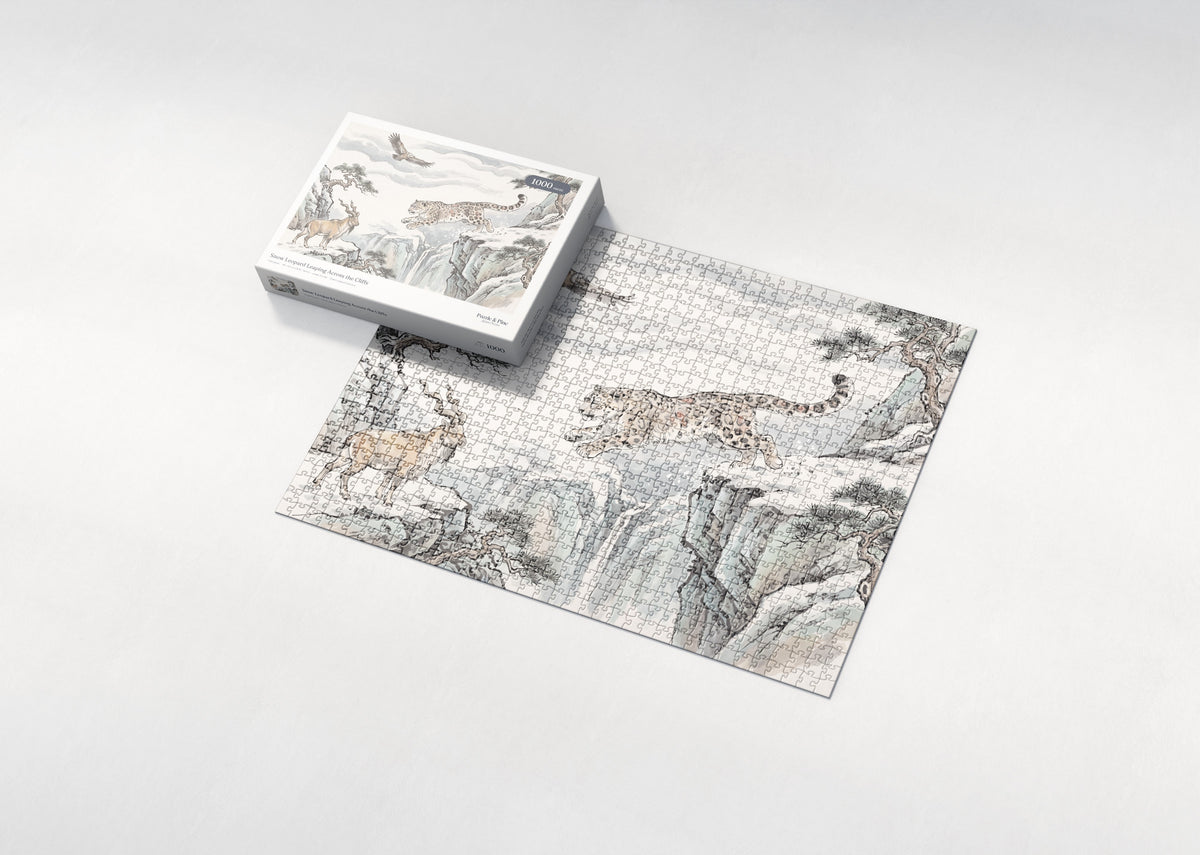 Snow Leopard Leaping Across the Cliffs jigsaw puzzle - box and puzzle